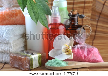 Cosmetics for  body, orchid and towel on  straw napkin