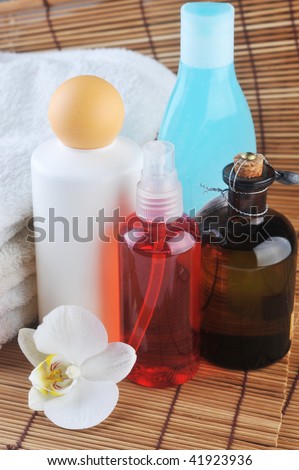 Cosmetics for  body, orchid and towel on  straw napkin