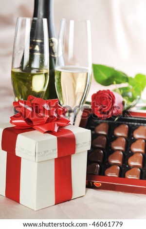 gift, champagne and red rose close-up