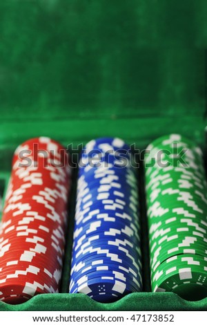 different color chips for gambling in box background.