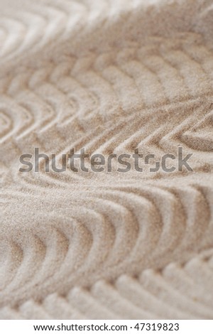 Waves on light sea sand close up