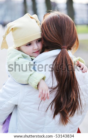 Mother holds  little girl on hands