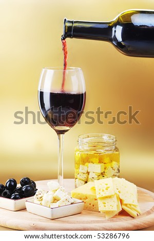 Red wine in wineglass cheese and olives