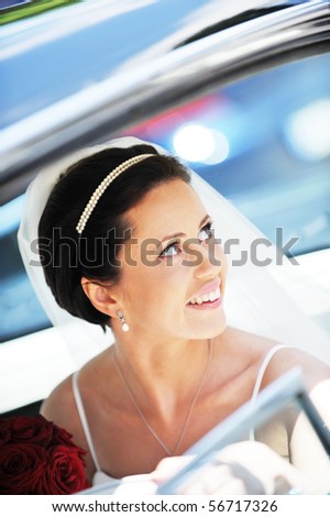 Bride with flowers in the car
