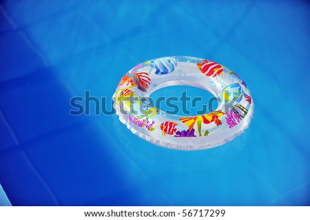 life ring floating in  blue water of swimming pool