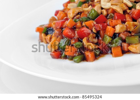 steamed vegetables and meat with  peanut on plate. Chinese cuisine.
