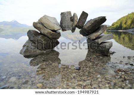 a bridge with stones and lake