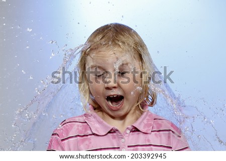 surprised young girl with water fountain on head