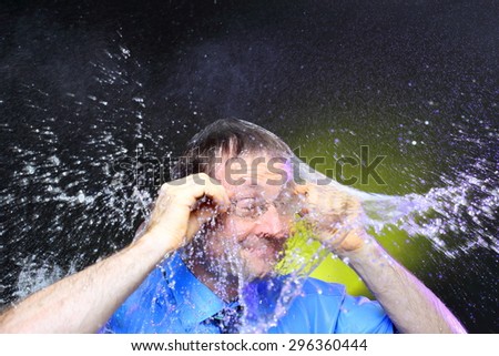 businessman with glasses is showering with water