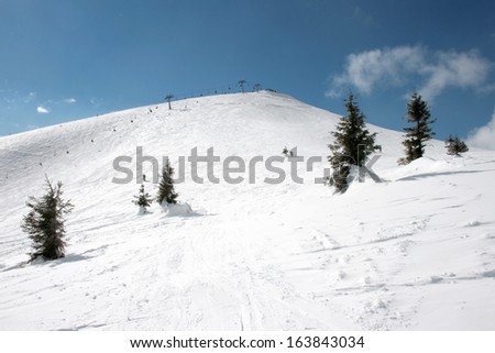 WInter ski resort snow mountains landscape with blue sky in summer sunny day. Dragobrat. Ukraine