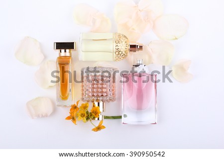 perfume bottles surrounded by rose flower (rose petals).