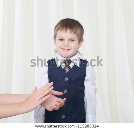 Little smart boy in suit takes applause from somebody