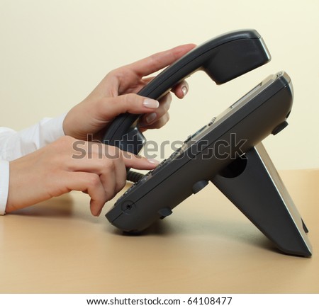 Female hands dialing phone number