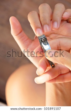 hand manicure with nail clipper