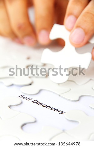 hand holding a puzzle piece, self discovery concept