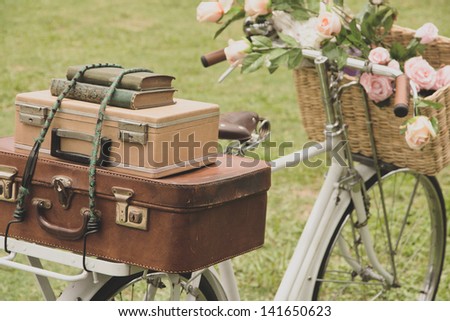 Vintage bicycle on the field with a bag and basket