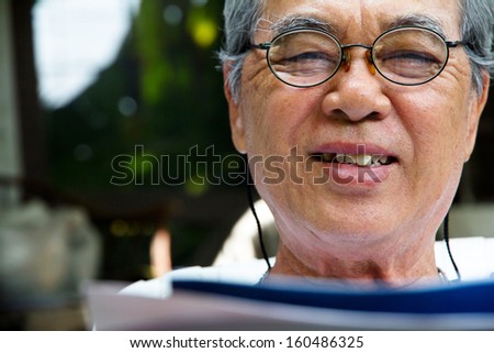 Portrait of smiling senior man with book