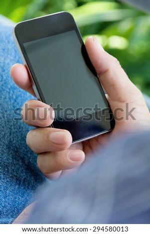 Close up of older man hand holding a smart phone