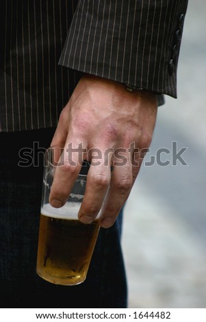 guy holding glass of beer