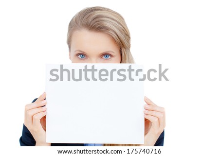 Smiling business woman holding a blank sheet of paper on white to write your text.