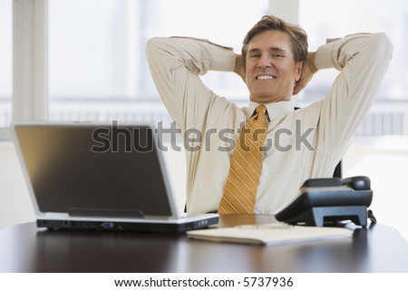 stock-photo-satisfied-business-executive-sitting-back-in-his-chair-5737936.jpg