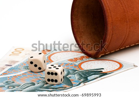 Two dices and some danish money on a white background