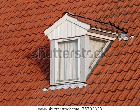 Dormer window on a red tile roof
