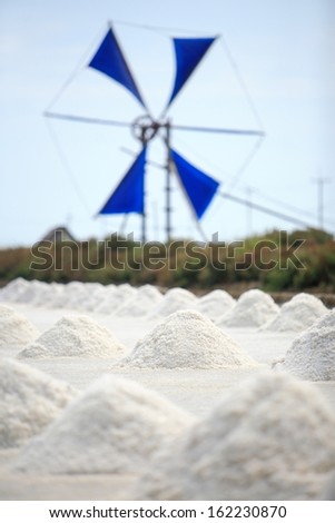 Salt pile in salt farm with windwheel, Thailand.