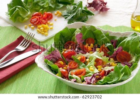 italian salad with lettuce, rocket, corn, tomatoes on the table
