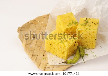 Indian food Dhokla topped with sesame seeds and green chillies