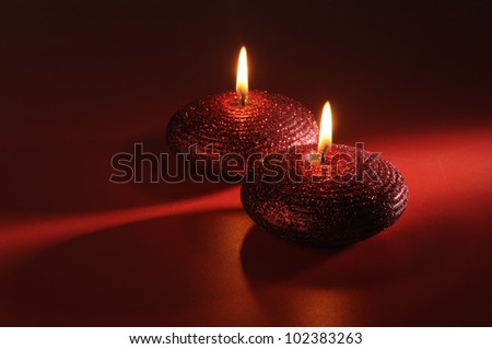 isolated red candles on dark red background