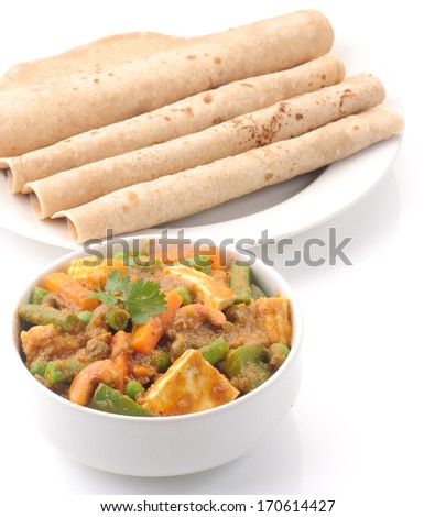 Chapati, chapathi, chapatti or flatbread, famous indian basic food isolated on white background.Spicy Indian vegetable curry with cauliflower, sweet potato, and carrot