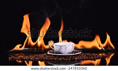 Fired cup of coffee with coffee beans on dark background