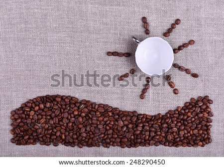 Composition cup of coffee with sun and sea made by coffee beans on linen texture table
