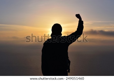Silhouette of a man on the sea sunset background