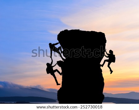 The joint work teamwork of two men travelers help each other on top of a mountain climbing team, a beautiful sunset landscape