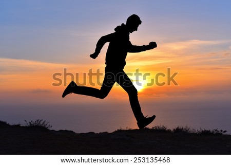 Running jumping man above sunset and mountain. Sport sky sun nature landscape