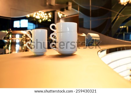 cup with tea, water, coffee on bar table in cafe restaurant bar