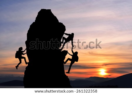 The joint work teamwork of two men travelers and girl help each other on top of a mountain climbing team, a beautiful sunset landscape