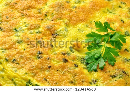 Frittata - italian omelette with parsley and parmesan cheese on a old wooden table, closeup