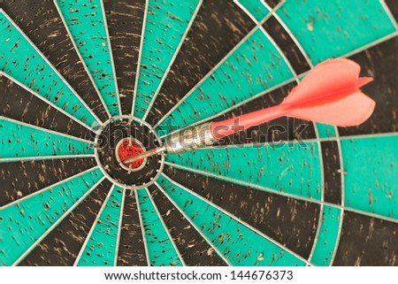 Dart board with red dart