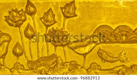 Walls decorated with golden lotus and fish stucco