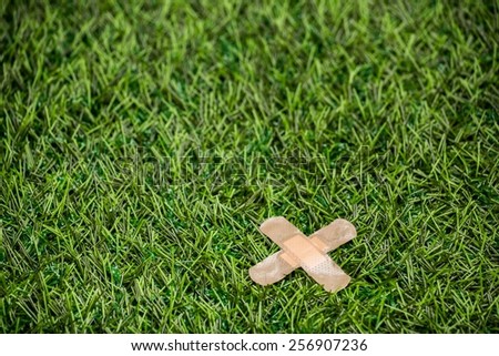 Adhesive plasters sticked to green grass