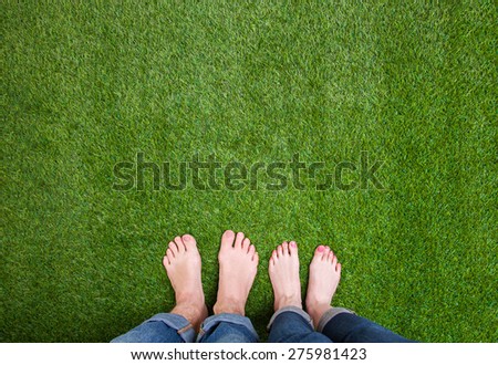 Men and woman  legs standing together on grass