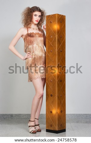 model standing with a lamp