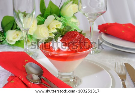 Dessert of yogurt with strawberry jelly with whipped cream and strawberries