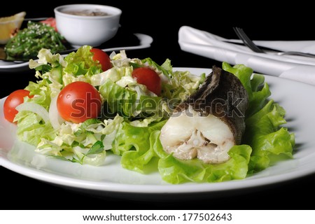 Baked fish (King clip) with a salad of green vegetables and cherry tomatoes