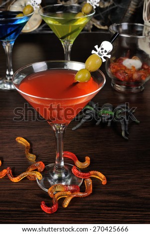 Cocktail with olives on a cocktail stick in honor of Halloween