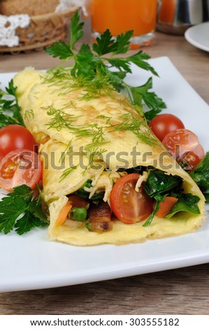 Omelet stuffed  vegetables with herbs and tomatoes
