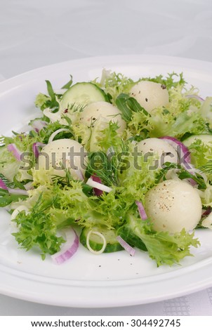 Arugula salad with cucumber with melon balls